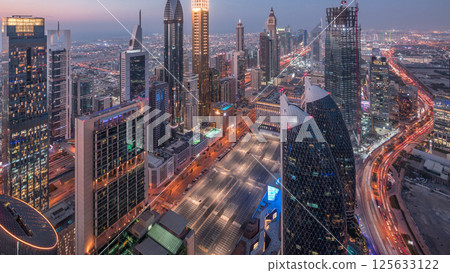 Skyline of the buildings of Sheikh Zayed Road and DIFC aerial day to night timelapse in Dubai, UAE. 125633122