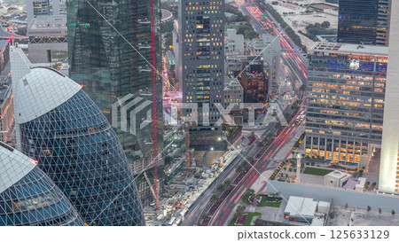 Skyline of the buildings of Sheikh Zayed Road and DIFC aerial day to night timelapse in Dubai, UAE. 125633129