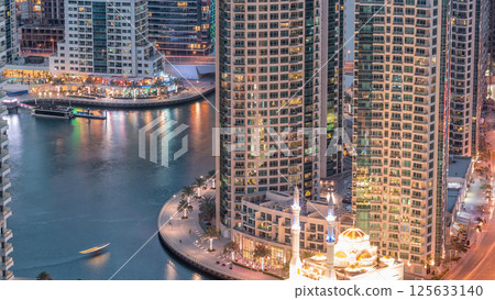 Modern residential architecture of Dubai Marina and Mohammed Bin Ahmed Almulla Mosque aerial day to night timelapse 125633140