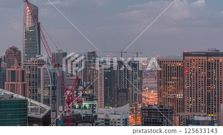 Dubai Marina skyscrapers and jumeirah lake towers view from the top aerial night to day timelapse in the United Arab Emirates. 125633143