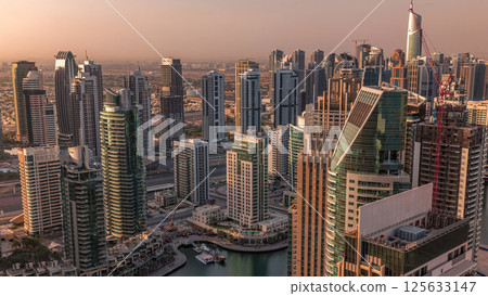 Dubai Marina skyscrapers and jumeirah lake towers sunrise view from the top aerial timelapse in the United Arab Emirates. 125633147