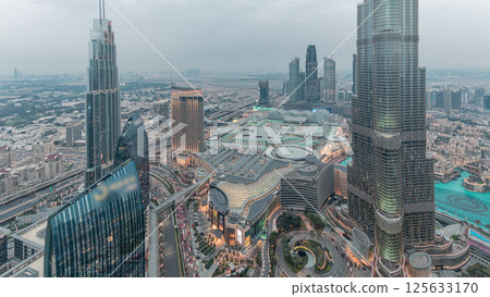 Panoramic skyline view of Dubai downtown with mall, fountains and Burj Khalifa aerial day to night timelapse Panoramic skyline view of Dubai downtown with mall, fountains and Burj Khalifa aerial day to night timelapse 125633170