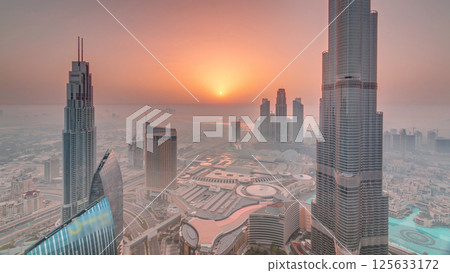 Panoramic skyline view of Dubai downtown during sunrise with mall, fountains and Burj Khalifa aerial morning timelapse Panoramic skyline view of Dubai downtown during sunrise with mall, fountains and Burj Khalifa aerial morning timelapse 125633172