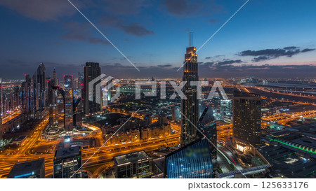 Dubai International Financial Centre district with modern skyscrapers night to day timelapse 125633176