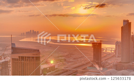 Amazing sunrise aerial view of Dubai downtown skyscrapers morning timelapse, Dubai, United Arab Emirates Amazing sunrise aerial view of Dubai downtown skyscrapers morning timelapse, Dubai, United Arab Emirates 125633178