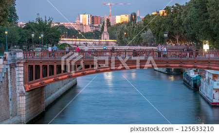 River and bridge near Notre Dame De Paris cathedral day to night timelapse after sunset. 125633210