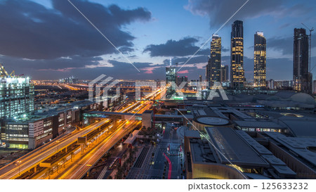 Aerial view of Financial center road night to day timelapse with under construction building 125633232
