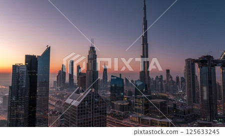 Dubai downtown skyline with tallest skyscrapers and busiest traffic on highway intersection night to day timelapse 125633245