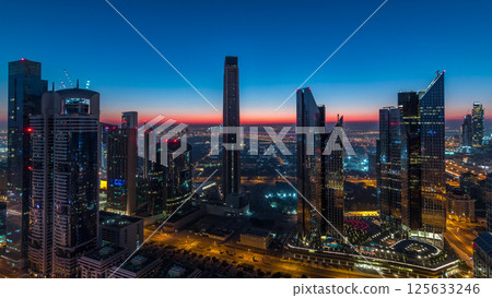 Dubai downtown skyline with tallest skyscrapers and traffic on highway night to day timelapse 125633246
