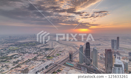 Downtown of Dubai in the morning timelapse during sunrise. Aerial view with towers and skyscrapers Downtown of Dubai in the morning timelapse during sunrise. Aerial view with towers and skyscrapers 125633261