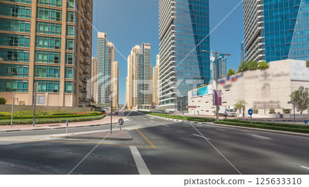 Dubai Marina with Skyscrapers timelapse hyperlapse and traffic on the street near concrete road bridge through the canal 125633310