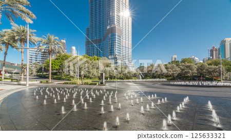 Fountains near main entrance to the tallest skyscraper timelapse hyperlapse, Dubai 125633321