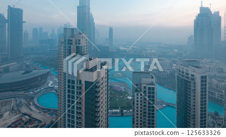 Foggy morning in downtown of Dubai night to day timelapse. 125633326