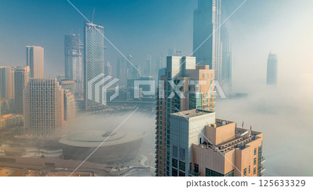 Foggy morning in downtown of Dubai timelapse. 125633329