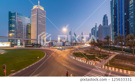 Traffic on intersection and bridge at the Sheikh Zayed Road day to night timelapse Traffic on intersection and bridge at the Sheikh Zayed Road day to night timelapse 125633331