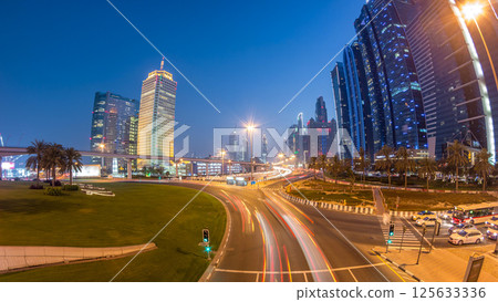 Traffic on intersection and bridge at the Sheikh Zayed Road day to night timelapse 125633336