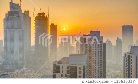 Foggy morning sunrise in downtown of Dubai timelapse. Foggy morning sunrise in downtown of Dubai timelapse. 125633337