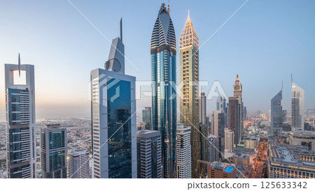 Skyline view of the buildings of Sheikh Zayed Road and DIFC day to night timelapse in Dubai, UAE. Skyline view of the buildings of Sheikh Zayed Road and DIFC day to night timelapse in Dubai, UAE. 125633342