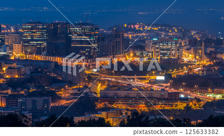 Panoramic view over Lisbon and Almada from a viewpoint in Monsanto night to day timelapse. Panoramic view over Lisbon and Almada from a viewpoint in Monsanto night to day timelapse. 125633382