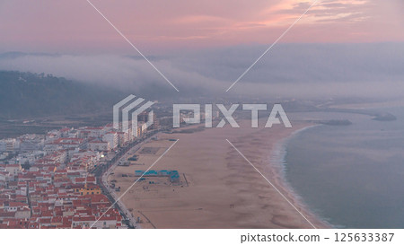 Nazare panorama with cabins of Funicular timelapse. Fog coming from ocean at evening during sunset. 125633387