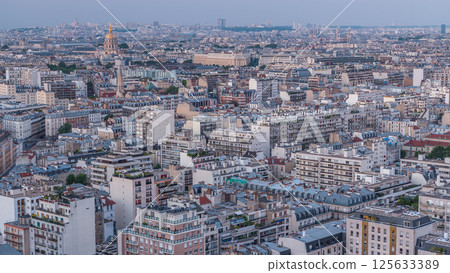 Aerial panorama above houses rooftops in a Paris day to night timelapse Aerial panorama above houses rooftops in a Paris day to night timelapse 125633389