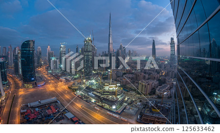 Dubai Downtown night to day timelapse. Aerial view over big futuristic city by night. 125633462