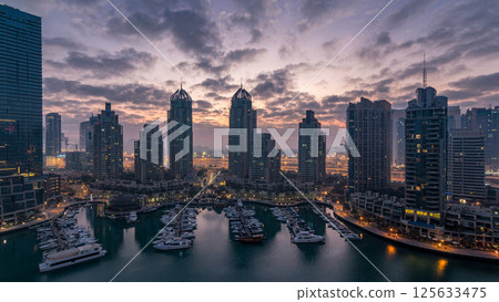 Aerial view of modern skyscrapers night to day timelapse before sunrise in Dubai Marina in Dubai, UAE. 125633475