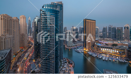 Evening illumination of Dubai Marina day to night aerial timelapse, UAE. Evening illumination of Dubai Marina day to night aerial timelapse, UAE. 125633479