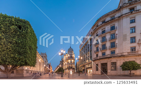 Illuminated Adriatica building on Avenida de la Constitucion at night, Seville, Spain 125633491