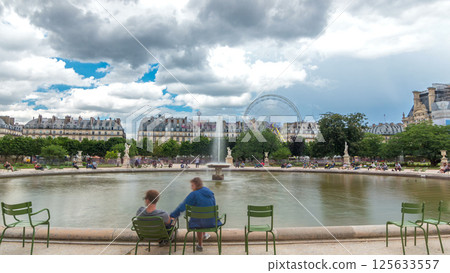 People relaxing in Tuileries Palace open air park near museum timelapse hyperlapse. Paris, France 125633557