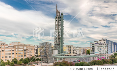 Timelapse hyperlapse of old steel refinery tower with spiral ramp in Lisbon's Park of Nations modern district. Portugal 125633627