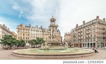Hyperlapse of Place des Jacobins in Lyon, France, featuring the ornate Fontaine des Jacobins surrounded by historic buildings. 125633654