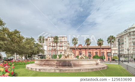 Hispalis Fountain in Seville surrounded by flowers and historical buildings timelapse 125633690