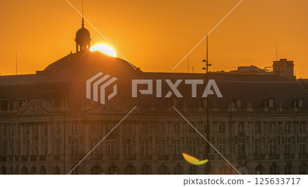 Sunset view of Bordeaux city skyline featuring spires and rooftops on a waterfront. 125633717