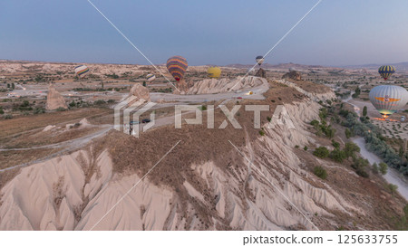 Aerial view from hot air balloon during Sunrise over the fairytale landscape hills of Kapadokya timelapse hyperlapse with morning light. 125633755