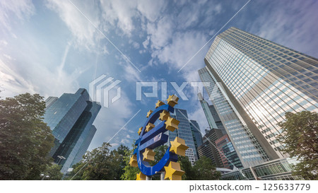 Timelapse hyperlapse of the Euro currency sign in downtown Frankfurt near the former headquarters of the European Central Bank. Germany Timelapse hyperlapse of the Euro currency sign in downtown Frankfurt near the former headquarters of the European Central Bank. Germany 125633779