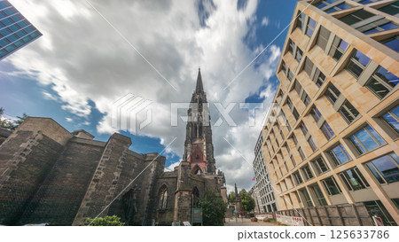Looking up perspective to the facade of Ehemalige Hauptkirche St. Nikolai timelapse hyperlapse in Hamburg, Germany Looking up perspective to the facade of Ehemalige Hauptkirche St. Nikolai timelapse hyperlapse in Hamburg, Germany 125633786