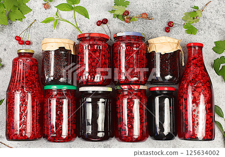 Jars with raspberry, cherry, gooseberry jam and compote on kitchen background with leaves and fresh berries, home canning concept, banner and advertisement of shop and market, village harvest, Jars with raspberry, cherry, gooseberry jam and compote on kitchen background with leaves and fresh berries, home canning concept, banner and advertisement of shop and market, village harvest, 125634002