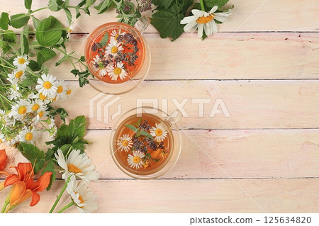 Floral composition of wild herbs and flowers on a wooden table in a rustic style, autumn background, tansy,  125634820