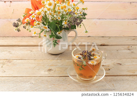 Floral composition of wild herbs and flowers on a wooden table in a rustic style, autumn background, tansy,  125634824
