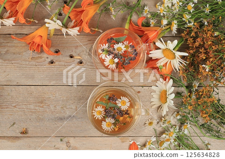 Floral composition of wild herbs and flowers on a wooden table in a rustic style, autumn background, tansy,  125634828