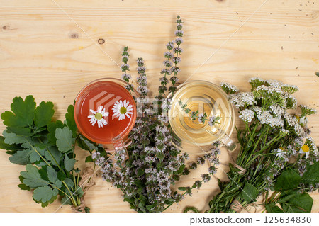 Floral composition of wild herbs and flowers on a wooden table in a rustic style, autumn background, tansy,  125634830