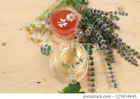 Floral composition of wild herbs and flowers on a wooden table in a rustic style, autumn background, tansy,  125634845