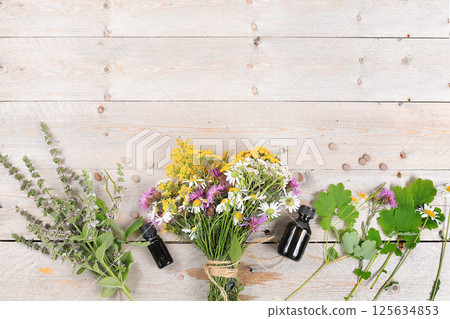 Floral composition of wild herbs and flowers on a wooden table in a rustic style, autumn background, tansy,  125634853