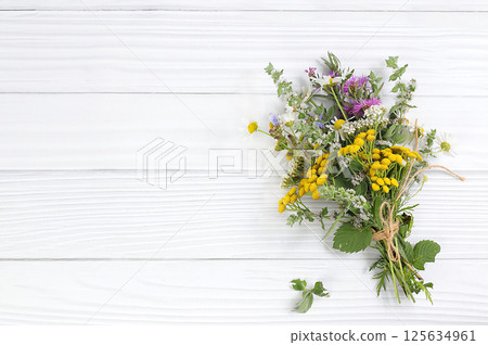 Floral arrangement of wild herbs and flowers on a wooden table, rustic style, autumn background, Bouquet of tansy, mint, celandine, chamomile and yarrow, collection of useful herbs for treatment Floral arrangement of wild herbs and flowers on a wooden table, rustic style, autumn background, Bouquet of tansy, mint, celandine, chamomile and yarrow, collection of useful herbs for treatment 125634961