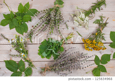 Autumn floral arrangement of wild herbs and leaves on old wooden background, alternative medicine concept Autumn floral arrangement of wild herbs and leaves on old wooden background, alternative medicine concept 125634968
