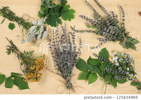 Autumn floral arrangement of wild herbs and leaves on old wooden background, alternative medicine concept 125634969