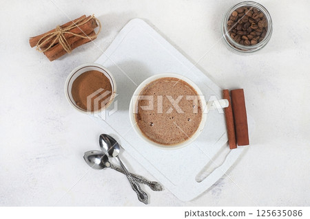 Coffee drink with milk and whipped cream, cappuccino coffee, latte, cinnamon, coffee beans on a gray concrete table, modern coffee shop advertisement, selective focus, top view, space for text, Coffee drink with milk and whipped cream, cappuccino coffee, latte, cinnamon, coffee beans on a gray concrete table, modern coffee shop advertisement, selective focus, top view, space for text, 125635086