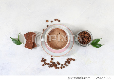 Coffee drink with milk, chocolate and whipped cream, cappuccino coffee, latte, cinnamon, coffee beans on a gray concrete table, modern coffee shop advertisement, selective focus, top view, space for 125635090