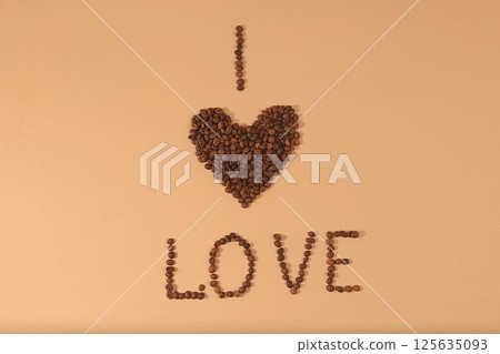 Heart shaped roasted coffee beans and text i love on beige background,top view,flat lay,minimal creative concept,advertising for modern coffee shop,cafe,bar,selective focus Heart shaped roasted coffee beans and text i love on beige background,top view,flat lay,minimal creative concept,advertising for modern coffee shop,cafe,bar,selective focus 125635093